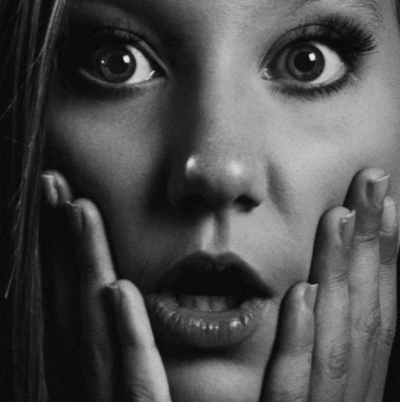 grayscale portrait photo of shocked woman